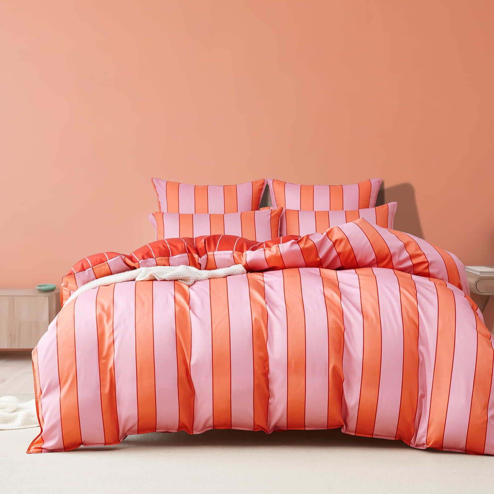 Rhythm Sunset quilt cover with oversized orange and soft pink stripes