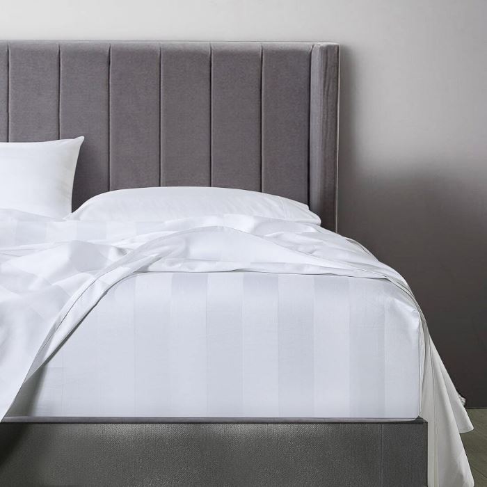 A bed with white Egyptian cotton sheets