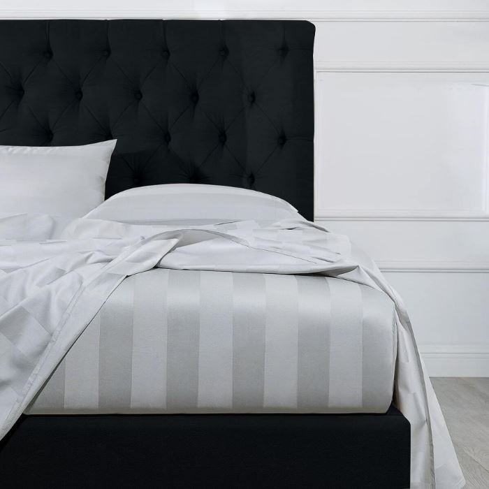Black bed with white bed sheet from Manchester Collection