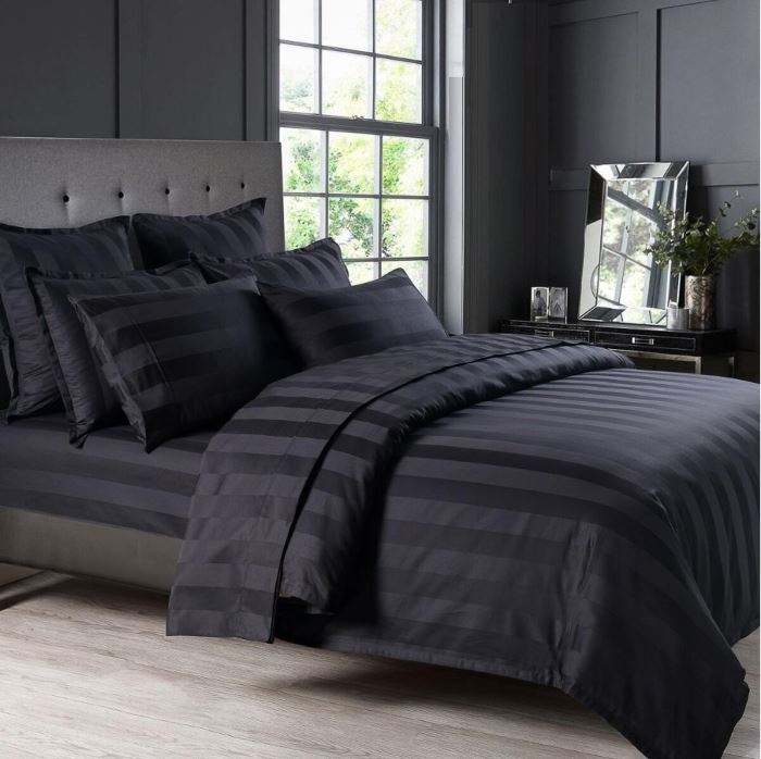 Black cooling sheet set on a bed