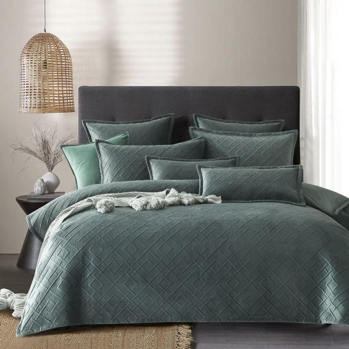 A bed with Forest green quilt cover from Manchester Collection