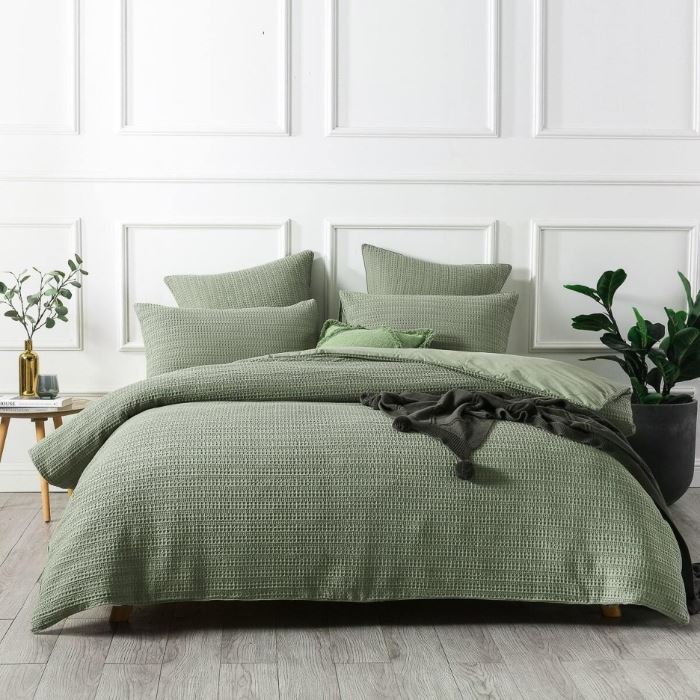 Green quilt cover on a bed - Manchester Collection