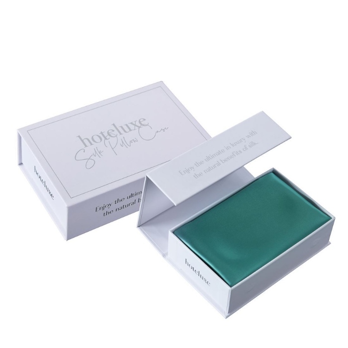 Hoteluxe white box with green silk pillowcase in it - Manchester Collection