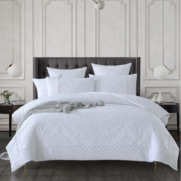 White quilt on a bed - Manchester Collection