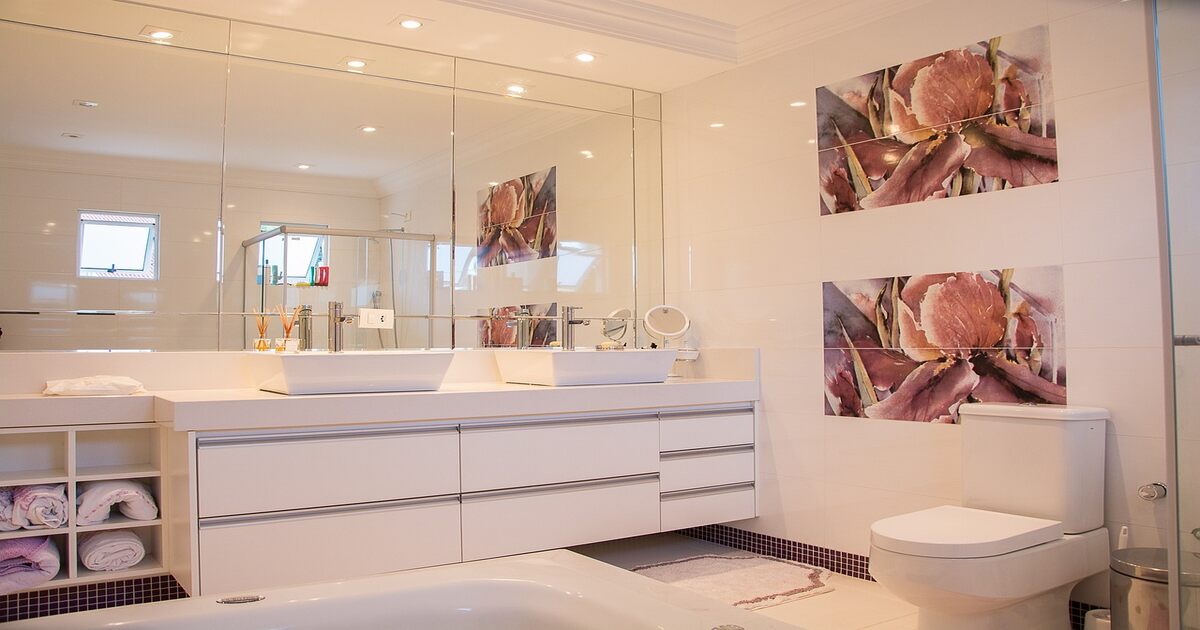 An image depicting a popular modern bathroom trend - wall art and mirrors.