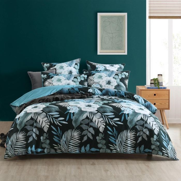 floral quilt cover on a bed in black and blue