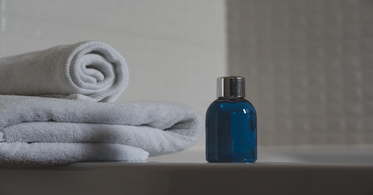 Three folded towels placed on a shelf.