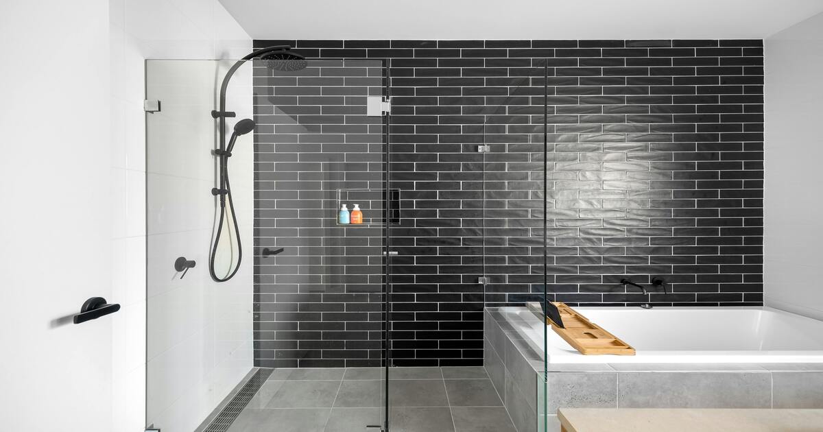 A hotel bathroom design that features an open shower next to a tub.