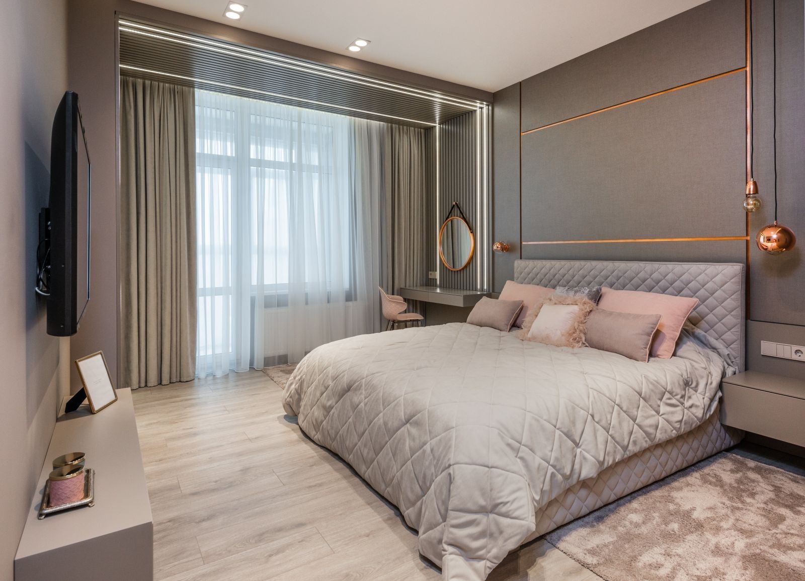 A stylish bed in a modern bedroom with a white quilt.